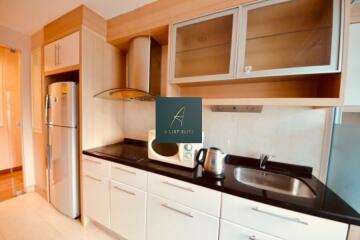 Modern kitchen with stainless steel appliances and wooden cabinets