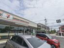 Exterior view of a 7-Eleven store and parked cars