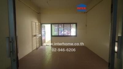 Empty living room with tiled floor and large window