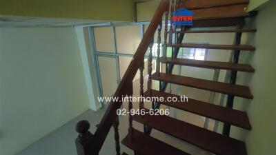 Staircase with wooden steps and railing