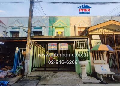 Front view of a residential building with a gate