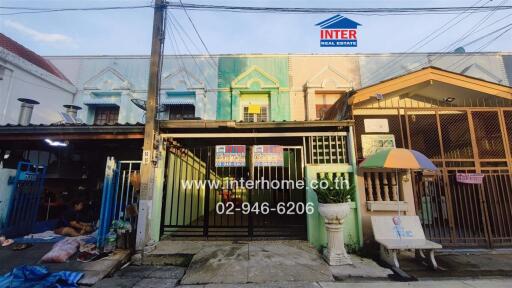 Front view of a residential building with a gate