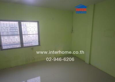 Bedroom with a window and green walls