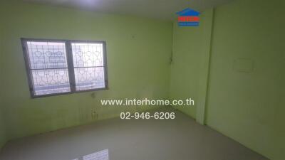 Bedroom with a window and green walls