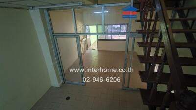 Spacious living area with stair access and glass doors