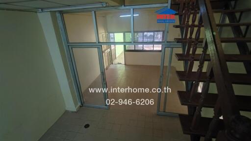 Spacious living area with stair access and glass doors