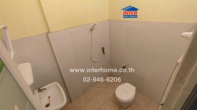 Compact bathroom with a shower, toilet, and bidet