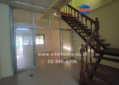 Main living space with staircase and glass partition