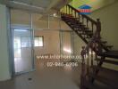 Main living space with staircase and glass partition