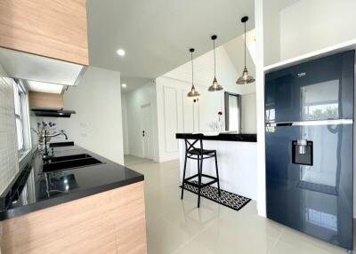 Modern kitchen with black countertops and wooden cabinets