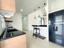 Modern kitchen with black countertops and wooden cabinets