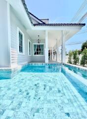 Outdoor pool area with a view of the house exterior