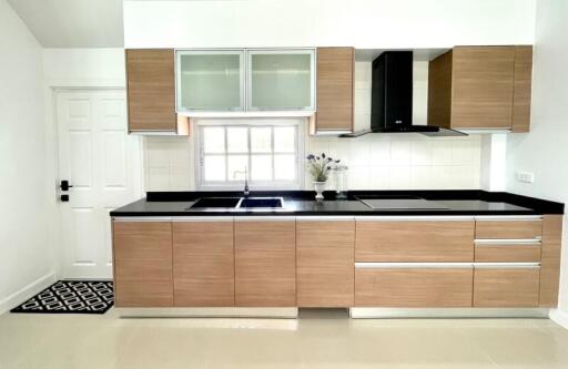 Modern Kitchen with Wooden Cabinets and Black Countertops