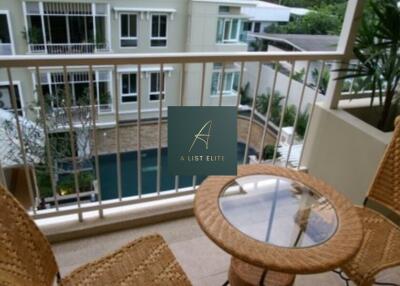 Balcony with seating area overlooking pool view