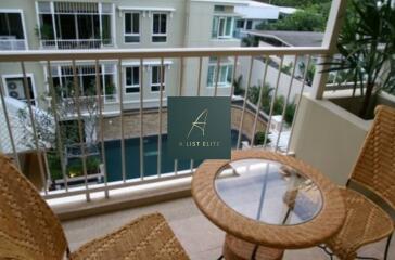 Balcony with seating area overlooking pool view