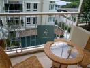 Balcony with seating area overlooking pool view