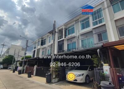 Exterior view of a modern townhouse complex on a cloudy day