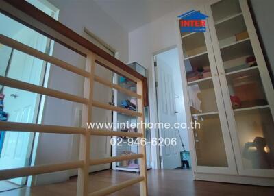 Interior of a building featuring hallway and storage cabinets