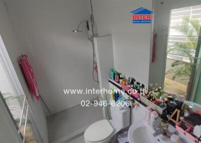 Bathroom with shower and various toiletries