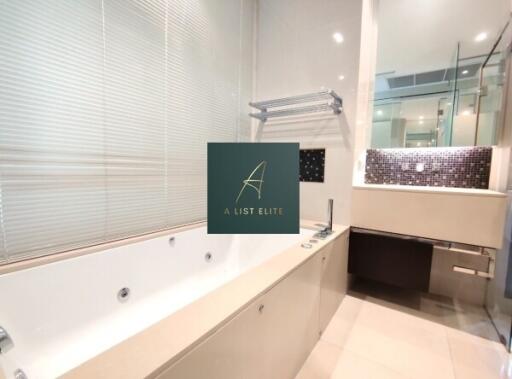 Modern bathroom with jacuzzi and large mirror