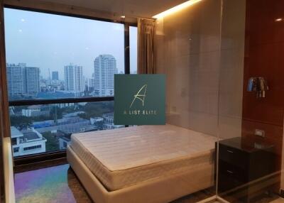 Bedroom with large window and city view