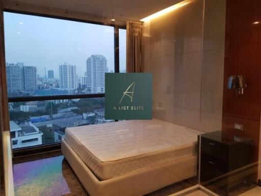 Bedroom with large window and city view