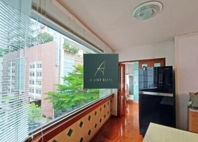 Modern kitchen area with large window and city view