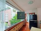 Modern kitchen area with large window and city view