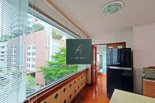 Modern kitchen area with large window and city view