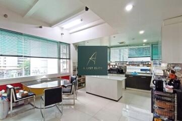 Modern kitchen with dining area and large windows