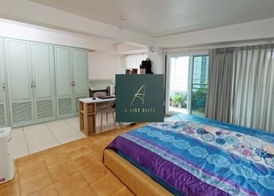 Spacious bedroom with sliding doors to balcony