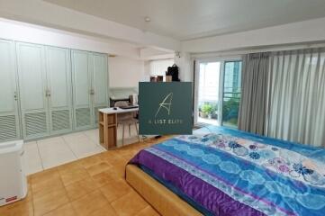 Spacious bedroom with sliding doors to balcony