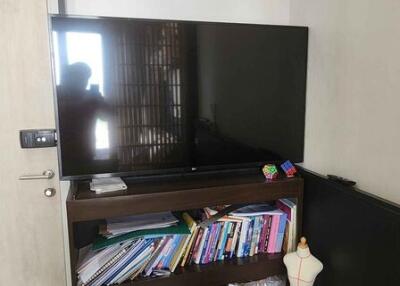 Living room with TV, bookcase, and air conditioner