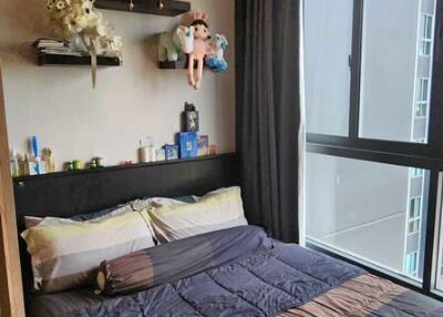 Cozy bedroom with a large window and decorative shelving