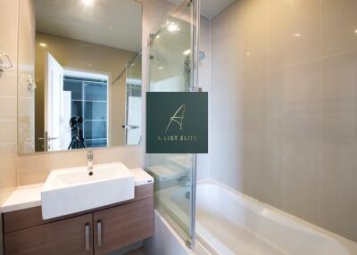 Modern bathroom with sink, vanity, bathtub, and mirror