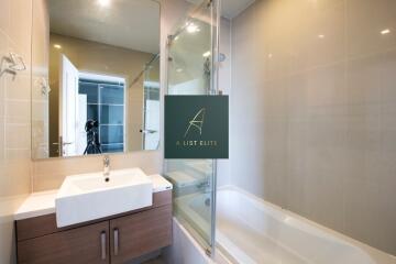 Modern bathroom with sink, vanity, bathtub, and mirror