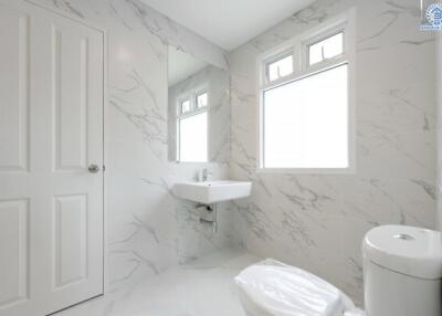 Modern white bathroom with marble wall tiles