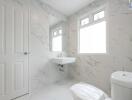 Modern white bathroom with marble wall tiles