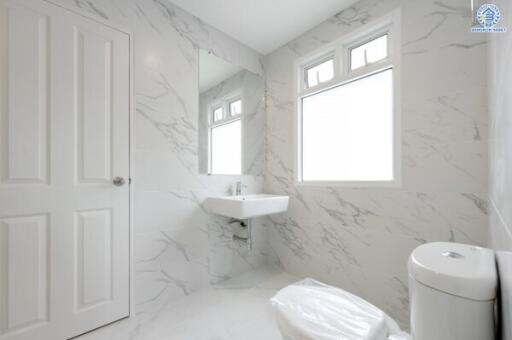 Modern white bathroom with marble wall tiles