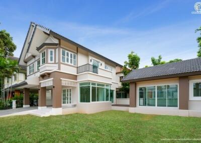 Exterior view of a modern two-story house with a well-maintained yard.