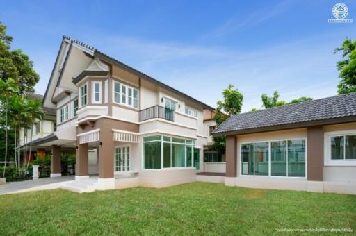 Exterior view of a modern two-story house with a well-maintained yard.