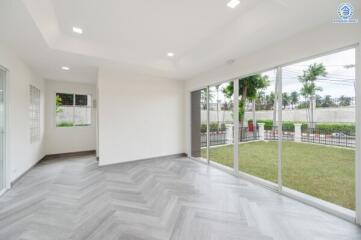 Spacious living area with large windows and garden view