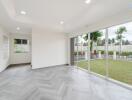 Spacious living area with large windows and garden view