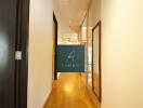 Well-lit hallway with wooden flooring and glass doors