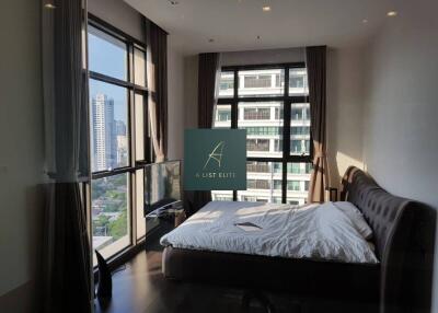 Modern bedroom with large windows and city view