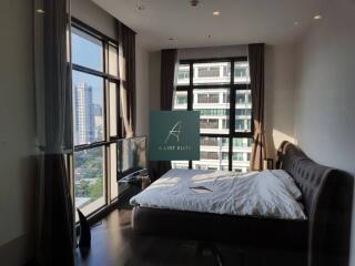 Modern bedroom with large windows and city view