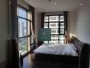 Modern bedroom with large windows and city view