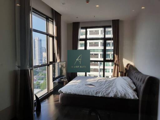 Modern bedroom with large windows and city view