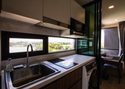 Modern kitchen with view, stove, sink, and appliances