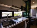 Modern kitchen with view, stove, sink, and appliances